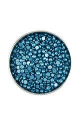 Top view of Titanium blue wax beans in a container for hair removal